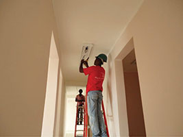 Electricians install a light