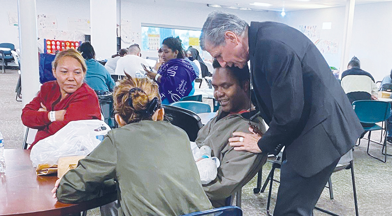 San Antonio Archbishop Gustavo García-Siller greets migrants at Centro de Bienvenida