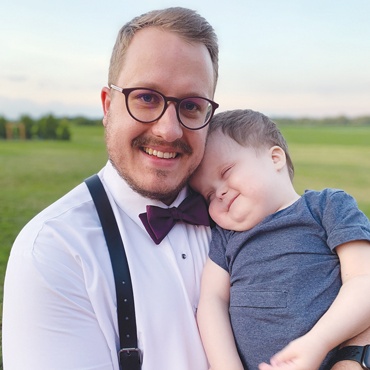 Chris Ostertag holds Hans, his then 3-year-old son.